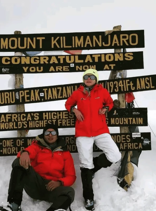 Two happy climbers on the summit of Mount Kilimanjaro. Picture Destination Kilimanjaro