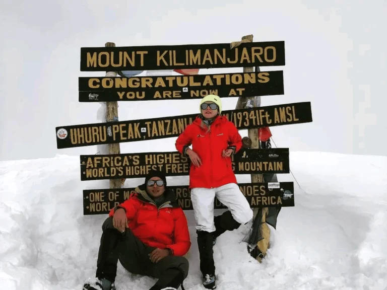 Two happy climbers on the summit of Mount Kilimanjaro. Picture Destination Kilimanjaro
